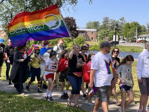 Pride flag and people walking in Napanee pride march