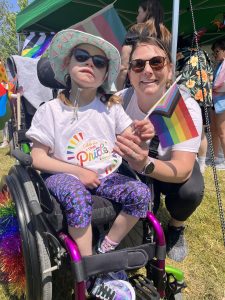 FACSFLA staff member with child at Napanee Pride March