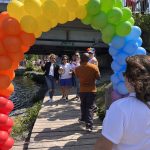 Rainbow arch of balloons during Napanee Pride March