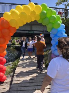 Rainbow arch of balloons during Napanee Pride March